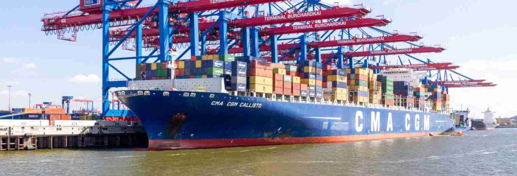Containers and palletized cargo at a marine terminal awaiting pickup before demurrage free time ends